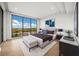 Main bedroom with large windows, plush bedding, and city views at 1591 Gulf Of Mexico Dr # 413, Longboat Key, FL 34228