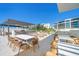 Relaxing rooftop terrace with pergola, grill, and seating area at 1591 Gulf Of Mexico Dr # 413, Longboat Key, FL 34228