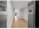 Modern hallway with elevator access and wood-look tile floors at 1591 Gulf Of Mexico Dr # 413, Longboat Key, FL 34228