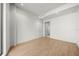 Bright bedroom with wood-look floors and access to a bathroom at 1591 Gulf Of Mexico Dr # 413, Longboat Key, FL 34228