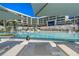 Relaxing resort pool with lounge chairs and umbrellas at 1591 Gulf Of Mexico Dr # 413, Longboat Key, FL 34228