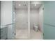 Contemporary bathroom with glass-enclosed shower and toilet at 1591 Gulf Of Mexico Dr # 413, Longboat Key, FL 34228