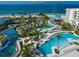 Resort-style pools with lush landscaping, swim-up bar, and ocean views at 1591 Gulf Of Mexico Dr # 413, Longboat Key, FL 34228