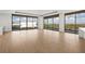 Bright living room featuring hardwood floors and access to a balcony at 1591 Gulf Of Mexico Dr # 413, Longboat Key, FL 34228