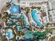Aerial view of resort with multiple pools, landscaping, and building at 1591 Gulf Of Mexico Dr # 413, Longboat Key, FL 34228