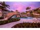 Resort pool with bridge and lounge chairs at sunset at 1591 Gulf Of Mexico Dr # 413, Longboat Key, FL 34228