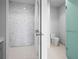 Modern bathroom features a frameless glass shower with horizontal tile surround and toilet at 1591 Gulf Of Mexico Drive # 311, Longboat Key, FL 34228
