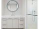 Bathroom featuring modern vanity with large round illuminated mirror and glass-enclosed shower at 1591 Gulf Of Mexico Drive # 311, Longboat Key, FL 34228
