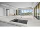 Modern kitchen with marble island and sink overlooking living room at 1591 Gulf Of Mexico Drive # 311, Longboat Key, FL 34228
