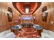 Unique lounge space with retro wood paneled walls and stylish seating around a central table at 1591 Gulf Of Mexico Drive # 311, Longboat Key, FL 34228