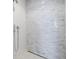 Modern shower featuring sleek fixtures and tiled wall design at 1591 Gulf Of Mexico Drive # 311, Longboat Key, FL 34228
