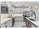 Modern kitchen with white cabinets and stainless steel appliances at 16247 Hidden Oak Loop, Bradenton, FL 34211