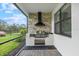 Outdoor kitchen with a built-in grill and stone facade at 16247 Hidden Oak Loop, Bradenton, FL 34211