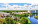 Aerial view showing community features including a lake, residential buildings, and a playground at 16247 Hidden Oak Loop, Bradenton, FL 34211