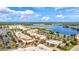 Aerial view of a vibrant community with lake, shops, and residential buildings at 16247 Hidden Oak Loop, Bradenton, FL 34211