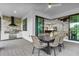 Outdoor kitchen with built-in grill and dining area at 16247 Hidden Oak Loop, Bradenton, FL 34211