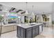 Open concept kitchen with large island, dark cabinets, and breakfast bar at 16247 Hidden Oak Loop, Bradenton, FL 34211