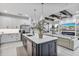 Open concept kitchen with island, stainless steel appliances and breakfast bar at 16247 Hidden Oak Loop, Bradenton, FL 34211