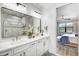 Double vanity bathroom with a large mirror and walk-in shower at 16247 Hidden Oak Loop, Bradenton, FL 34211