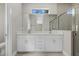 Stylish bathroom with dual sinks, quartz countertops, and tiled shower at 1800 S San Mateo Dr, North Port, FL 34288
