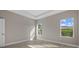 Bedroom features wood-look flooring and natural light from two windows at 1800 S San Mateo Dr, North Port, FL 34288