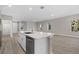 Modern kitchen featuring quartz countertops, stainless appliances, and light wood flooring at 1800 S San Mateo Dr, North Port, FL 34288