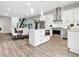 Modern kitchen with stainless steel appliances, white cabinetry, and an island at 2415 Floyd St, Sarasota, FL 34239