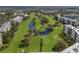 Panoramic aerial view of lush golf course community with mature trees and serene water features at 3660 Ironwood Cir # 101M, Bradenton, FL 34209