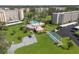 Aerial view of a community center with a pool, shuffleboard, and manicured lawns at 3660 Ironwood Cir # 101M, Bradenton, FL 34209