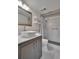 Updated bathroom featuring a modern vanity, toilet, and shower with white tile at 3660 Ironwood Cir # 101M, Bradenton, FL 34209