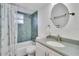Bathroom with shower-tub combo, white vanity, and oval mirror at 3660 Ironwood Cir # 101M, Bradenton, FL 34209