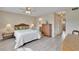 Well-lit bedroom with a ceiling fan, bedside tables, and an en-suite bathroom at 3660 Ironwood Cir # 101M, Bradenton, FL 34209
