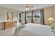 Cozy bedroom with natural light, neutral tones, and access to an outdoor patio area at 3660 Ironwood Cir # 101M, Bradenton, FL 34209