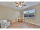 Bright bedroom with a ceiling fan, wood floors, and a large window for natural light at 3660 Ironwood Cir # 101M, Bradenton, FL 34209