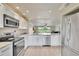 Bright, modern kitchen featuring stainless steel appliances and open layout to living area at 3660 Ironwood Cir # 101M, Bradenton, FL 34209