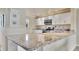 Bright kitchen featuring granite countertops and modern appliances at 3660 Ironwood Cir # 101M, Bradenton, FL 34209