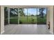 Bright enclosed lanai offering views of green lawns and mature landscaping, ideal for relaxing at 3660 Ironwood Cir # 101M, Bradenton, FL 34209