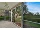 Screened lanai with golf course views through large glass sliders at 3660 Ironwood Cir # 101M, Bradenton, FL 34209