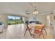Open-concept living and dining area with plenty of natural light and views of the green space at 3660 Ironwood Cir # 101M, Bradenton, FL 34209
