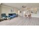 Spacious living room featuring a blue sofa, dining area, and views into the kitchen at 3660 Ironwood Cir # 101M, Bradenton, FL 34209