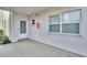 Private, covered tiled entry patio with a storm door and a large window with natural light at 3660 Ironwood Cir # 101M, Bradenton, FL 34209