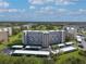 Aerial view of a large apartment building with parking and green space at 3660 Ironwood Cir # 101M, Bradenton, FL 34209