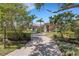 Elegant single-Gathering home with a brick driveway and manicured landscaping at 4008 Founders Club Dr, Sarasota, FL 34240