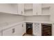 Spacious pantry with white cabinets, open shelving, and wine cooler at 4008 Founders Club Dr, Sarasota, FL 34240