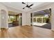 Living room with hardwood floors and sliding doors to the lanai and pool at 4008 Founders Club Dr, Sarasota, FL 34240