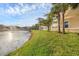 Picturesque view of the lake and community buildings at 4239 Expedition Way, Osprey, FL 34229