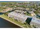 Aerial view of condo building with parking and waterfront canal views at 4452 Garnet Dr # 205, New Port Richey, FL 34652
