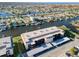 Aerial view of condo building with parking and canal-side location at 4452 Garnet Dr # 205, New Port Richey, FL 34652