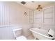 Bathroom with clawfoot tub, built-in shelving, and wainscoting at 4452 Garnet Dr # 205, New Port Richey, FL 34652