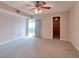 Spacious bedroom with neutral carpeting and access to a balcony at 4452 Garnet Dr # 205, New Port Richey, FL 34652